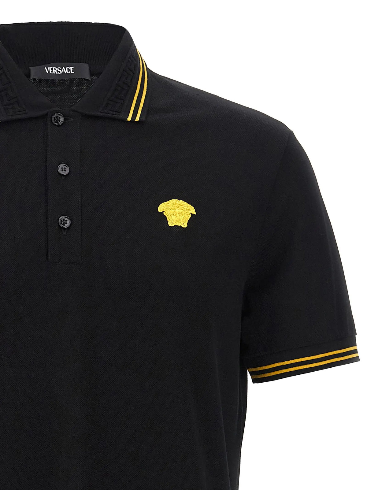 Polo versace noir en coton avec tête de meduse brodée en or et rayures assorties sur col et manches