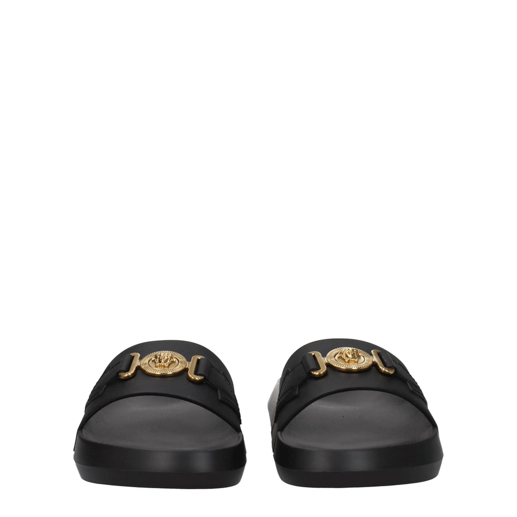 Versace black leather slippers with black slide sandals featuring a gold-tone medusa head buckle