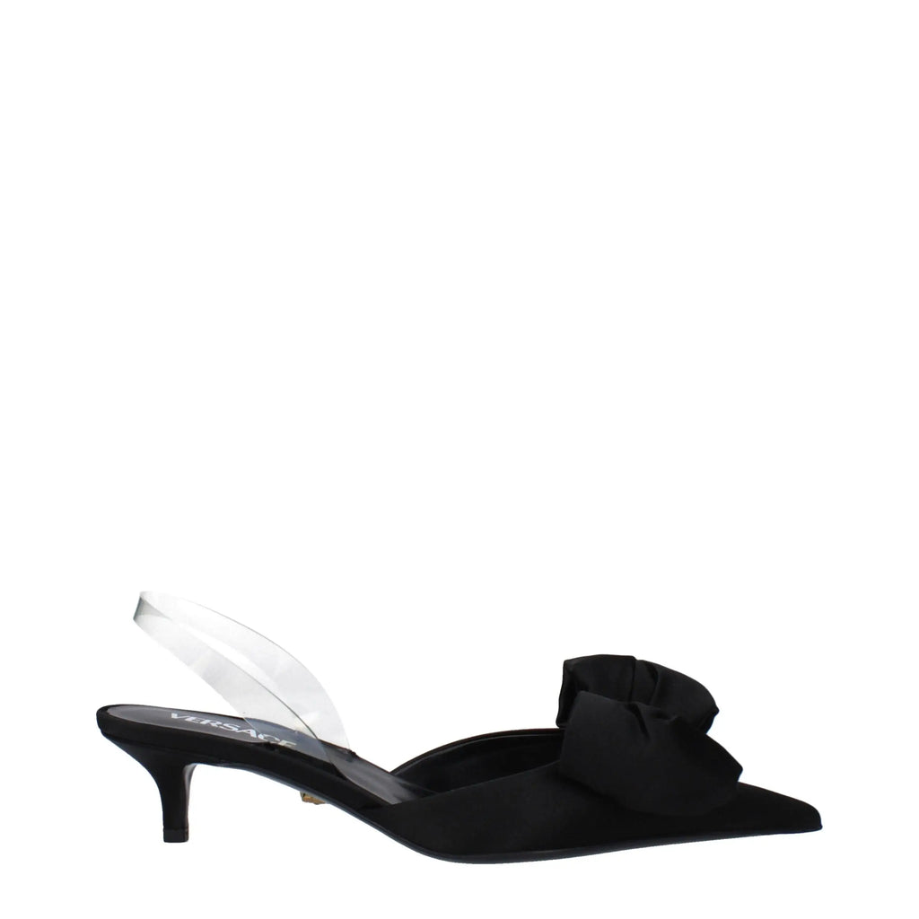 Sandales plates versace noires en satin avec bride slingback transparente et grand nœud volanté au bout