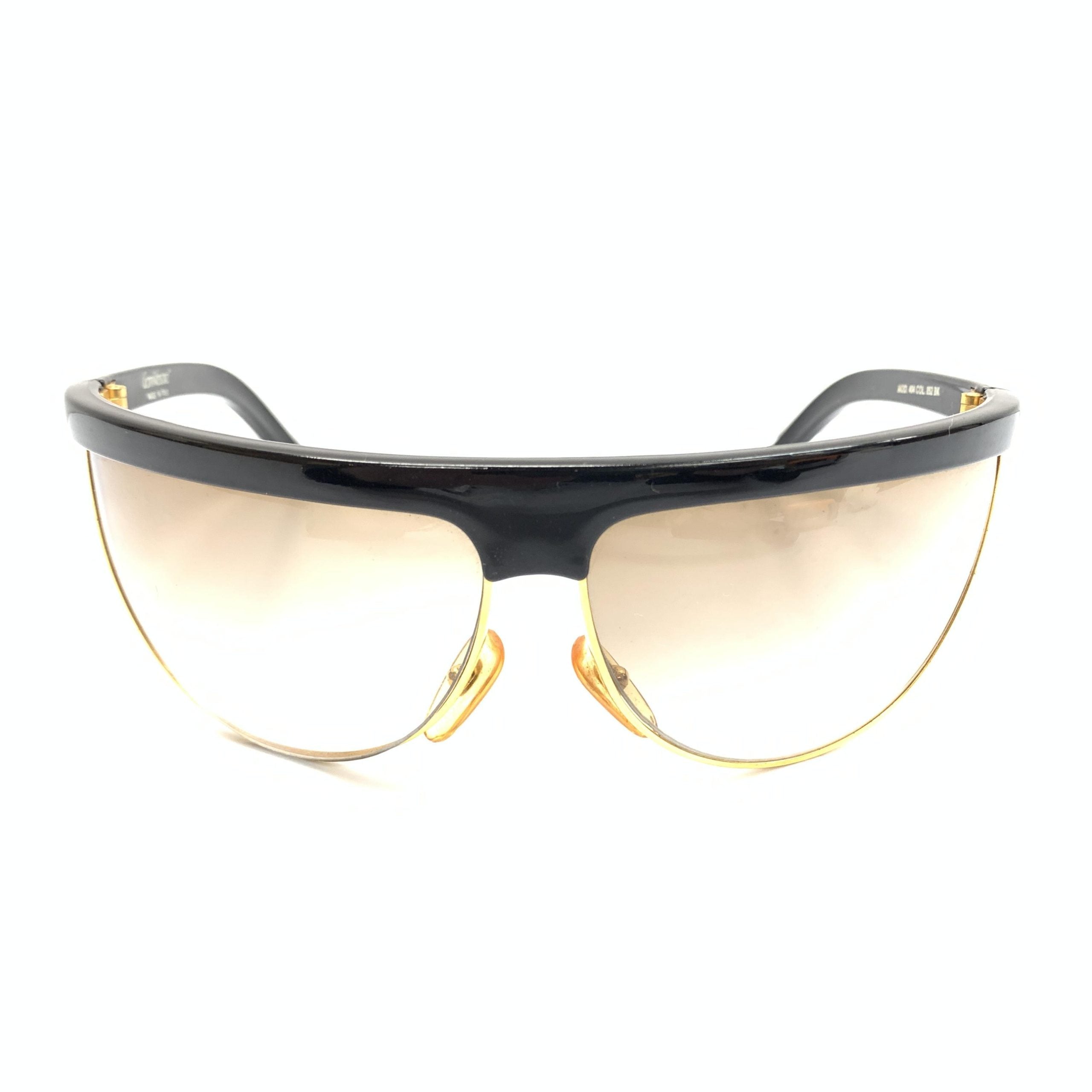 Lunettes de soleil de sport polarisées Versace Versache avec monture élégante et verres protecteurs, pour un style sportif et sophistiqué.