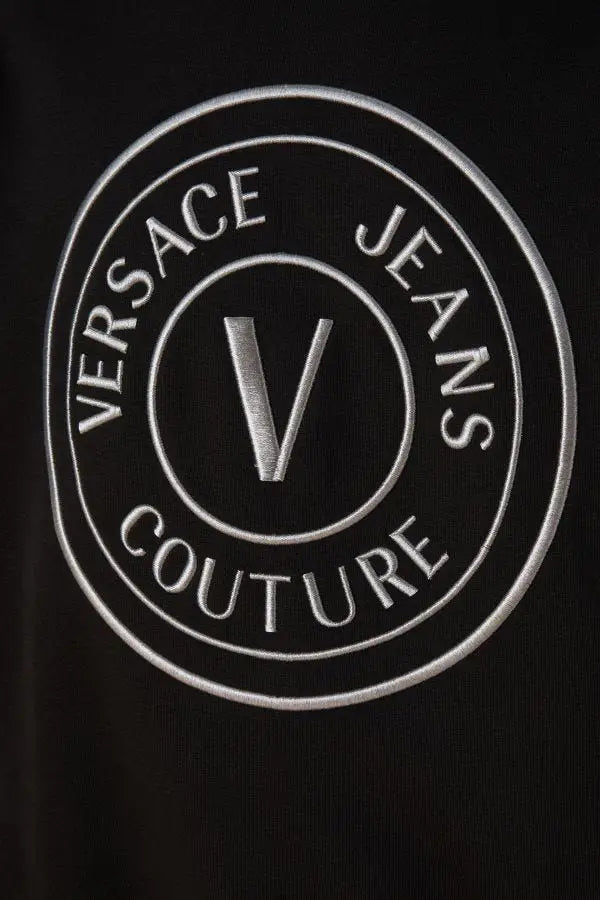 Patch logo couture versace jeans noir en coton avec broderie argentée sur sweat à capuche versace jeans
