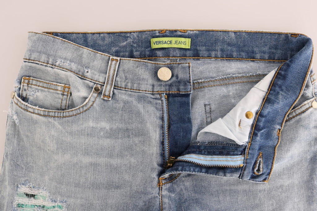 Jeans slim stretch déchirés bleus Versace Jeans, coupe ajustée, style décontracté, vue frontale.
