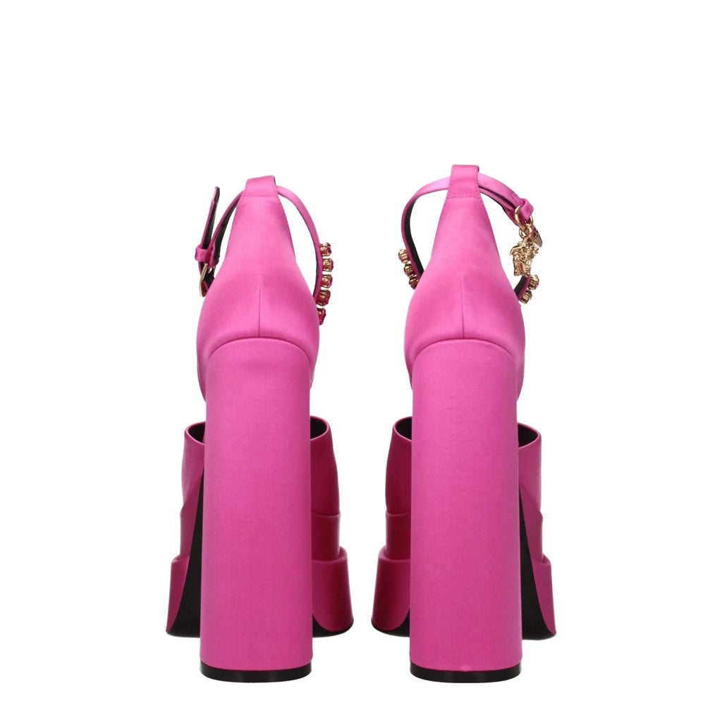 Versace pink satin platform sandals with vibrant pink satin, gold-tone medusa head charms, and sleek structured design