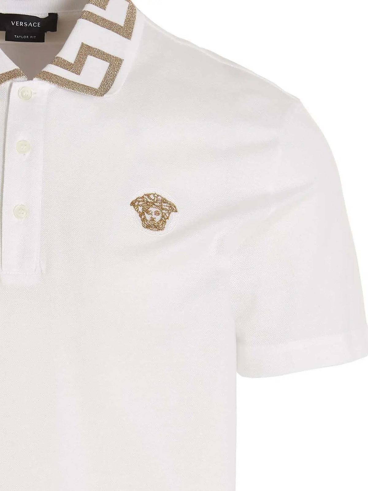 Polo versace blanc en coton avec tête de médusa brodée dorée et motif géométrique assorti sur le col